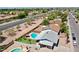 Aerial view of the home with a sparkling blue pool, a lush lawn, a covered patio, and a fence at 2207 W Bentrup St, Chandler, AZ 85224