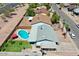Backyard featuring a sparkling blue pool, lush lawn, covered patio, and desert landscaping at 2207 W Bentrup St, Chandler, AZ 85224