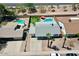 This aerial shows a home with a private pool, lush landscaping, and convenient driveway at 2207 W Bentrup St, Chandler, AZ 85224