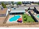 Backyard featuring a sparkling pool, patio space, green lawn, and privacy fence for outdoor enjoyment at 2207 W Bentrup St, Chandler, AZ 85224