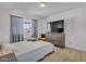 Bright bedroom with wood floors, window with gray curtains, and a large dresser at 2207 W Bentrup St, Chandler, AZ 85224