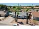 Aerial view of a quaint single-story home with desert landscaping, palm trees, and a gray shingle roof at 2207 W Bentrup St, Chandler, AZ 85224