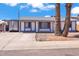 Charming single-story home with a white exterior and blue trim and a large palm tree in the front yard at 2207 W Bentrup St, Chandler, AZ 85224