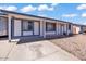 Inviting single-story home with a white exterior and blue trim, a covered driveway and well-maintained landscaping at 2207 W Bentrup St, Chandler, AZ 85224