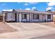 Inviting single-story home with a white exterior and blue trim, a covered driveway and well-maintained landscaping at 2207 W Bentrup St, Chandler, AZ 85224