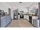 Updated kitchen features stainless steel appliances and stylish white cabinetry at 2207 W Bentrup St, Chandler, AZ 85224