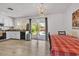 Kitchen dining with chandelier, white cabinets, and view to swimming pool at 2207 W Bentrup St, Chandler, AZ 85224