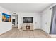Inviting living room boasts an electric fireplace and light wood-look flooring at 2207 W Bentrup St, Chandler, AZ 85224