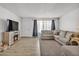 Open-concept living space with light wood floors and a cozy sectional sofa at 2207 W Bentrup St, Chandler, AZ 85224