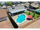 Aerial view of a backyard with a fenced pool area, a well-maintained lawn, and a covered patio at 2207 W Bentrup St, Chandler, AZ 85224