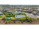 An aerial view of a neighborhood showcasing lush landscaping, backyard pools, and well-maintained homes at 22353 N 99Th Ln, Peoria, AZ 85383