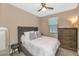 Cozy bedroom with a plush bed, dresser, and a neutral color scheme at 22353 N 99Th Ln, Peoria, AZ 85383