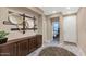 Chic entryway featuring modern circular mirrors, a brown credenza, and neutral tile flooring at 22353 N 99Th Ln, Peoria, AZ 85383