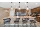 Spacious kitchen featuring a large island, granite countertops, stainless steel appliances, and pendant lights at 22353 N 99Th Ln, Peoria, AZ 85383