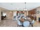 Open-concept kitchen and dining area featuring tile floors, a large island, and stainless steel appliances at 22353 N 99Th Ln, Peoria, AZ 85383