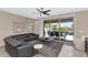 Comfortable living room with a ceiling fan, a leather sectional, and sliding glass doors to the patio at 22353 N 99Th Ln, Peoria, AZ 85383