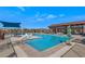 Resort-style pool area with lounge chairs and covered seating for relaxing outdoors on a sunny day at 22353 N 99Th Ln, Peoria, AZ 85383