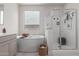 Bright bathroom featuring a soaking tub, a glass shower, and a neutral color palette at 22853 E Calle Luna --, Queen Creek, AZ 85142