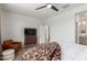 Bright bedroom with a ceiling fan, an accent chair, and view into the ensuite bath at 22853 E Calle Luna --, Queen Creek, AZ 85142
