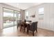 Bright dining room with paneled walls, modern sliding glass door, and a wooden dining table set at 22853 E Calle Luna --, Queen Creek, AZ 85142