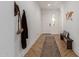 Bright entryway featuring herringbone floors, a long rug, wooden bench, and coat rack at 22853 E Calle Luna --, Queen Creek, AZ 85142