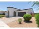 Single-Gathering home featuring a dark two-car garage, desert landscaping, and covered porch entry at 22853 E Calle Luna --, Queen Creek, AZ 85142