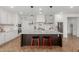 Modern kitchen with stainless steel appliances, white cabinets, a spacious center island, and decorative lighting at 22853 E Calle Luna --, Queen Creek, AZ 85142
