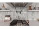 Modern kitchen features stainless steel appliances, marble backsplash, and floating shelves at 22853 E Calle Luna --, Queen Creek, AZ 85142