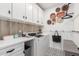 This practical laundry room has modern appliances, ample storage, and stylish flooring at 22853 E Calle Luna --, Queen Creek, AZ 85142