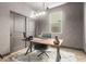 This stylish office is complete with an accent wall, floating shelves, and modern lighting at 22853 E Calle Luna --, Queen Creek, AZ 85142