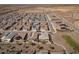 Wide aerial shot of a residential neighborhood with solar panels and green spaces at 24847 N 175Th Dr, Surprise, AZ 85387