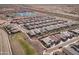 Expansive aerial view of the residential community with a clubhouse and lake at 24847 N 175Th Dr, Surprise, AZ 85387