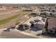 Stunning aerial view of the home with a three car garage and solar panels in a planned community at 24847 N 175Th Dr, Surprise, AZ 85387