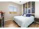 Relaxing bedroom with a comfortable bed, stylish artwork, and a bright window at 24847 N 175Th Dr, Surprise, AZ 85387