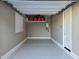 A compact garage with epoxy floors and convenient overhead storage, and adjacent white door at 24847 N 175Th Dr, Surprise, AZ 85387