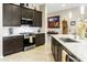 Modern kitchen featuring granite countertops, stainless steel appliances, and dark wood cabinets at 24847 N 175Th Dr, Surprise, AZ 85387