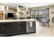 Open-concept kitchen with large island, stainless steel appliances, and seamless flow to dining and living areas at 24847 N 175Th Dr, Surprise, AZ 85387