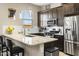 Well-equipped kitchen boasts stainless steel appliances, granite countertops, and stylish bar stool seating at 24847 N 175Th Dr, Surprise, AZ 85387
