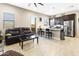 Cozy living space features a comfortable leather sofa, tile floors, and adjacent kitchen at 24847 N 175Th Dr, Surprise, AZ 85387