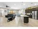 Open-concept living room and kitchen with modern appliances and a large island at 24847 N 175Th Dr, Surprise, AZ 85387
