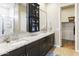 A bright, modern main bathroom boasts a double sink vanity, a walk-in closet, and a glass shower at 24847 N 175Th Dr, Surprise, AZ 85387