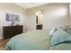 A neutral main bedroom reveals ensuite access, a wood dresser, and recessed lighting at 24847 N 175Th Dr, Surprise, AZ 85387