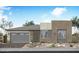 Modern single-story home featuring a two-car garage, neutral stucco, and well-maintained landscaping at 2576 E Tapenade Dr, San Tan Valley, AZ 85140