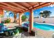 Inviting covered back patio with comfortable seating area and a view of the sparkling pool at 2843 E Captain Dreyfus Ave, Phoenix, AZ 85032