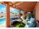 Relaxing covered back patio featuring cozy seating arrangements and direct access to the pool area at 2843 E Captain Dreyfus Ave, Phoenix, AZ 85032
