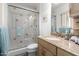 Bathroom featuring vanity with granite counters, tiled shower with glass doors, and ample light at 2843 E Captain Dreyfus Ave, Phoenix, AZ 85032