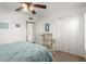A comfortable bedroom featuring a ceiling fan, complemented by closet and shelving space at 2843 E Captain Dreyfus Ave, Phoenix, AZ 85032