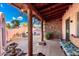 A covered courtyard features a stone fireplace, seating area, and lush landscaping at 2843 E Captain Dreyfus Ave, Phoenix, AZ 85032