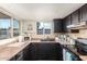 Bright kitchen area featuring stainless steel appliances, dark cabinets, and a breakfast bar counter at 2843 E Captain Dreyfus Ave, Phoenix, AZ 85032