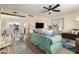 Inviting living room with a plush teal sofa, warm wood floors, and a large flatscreen television at 2843 E Captain Dreyfus Ave, Phoenix, AZ 85032